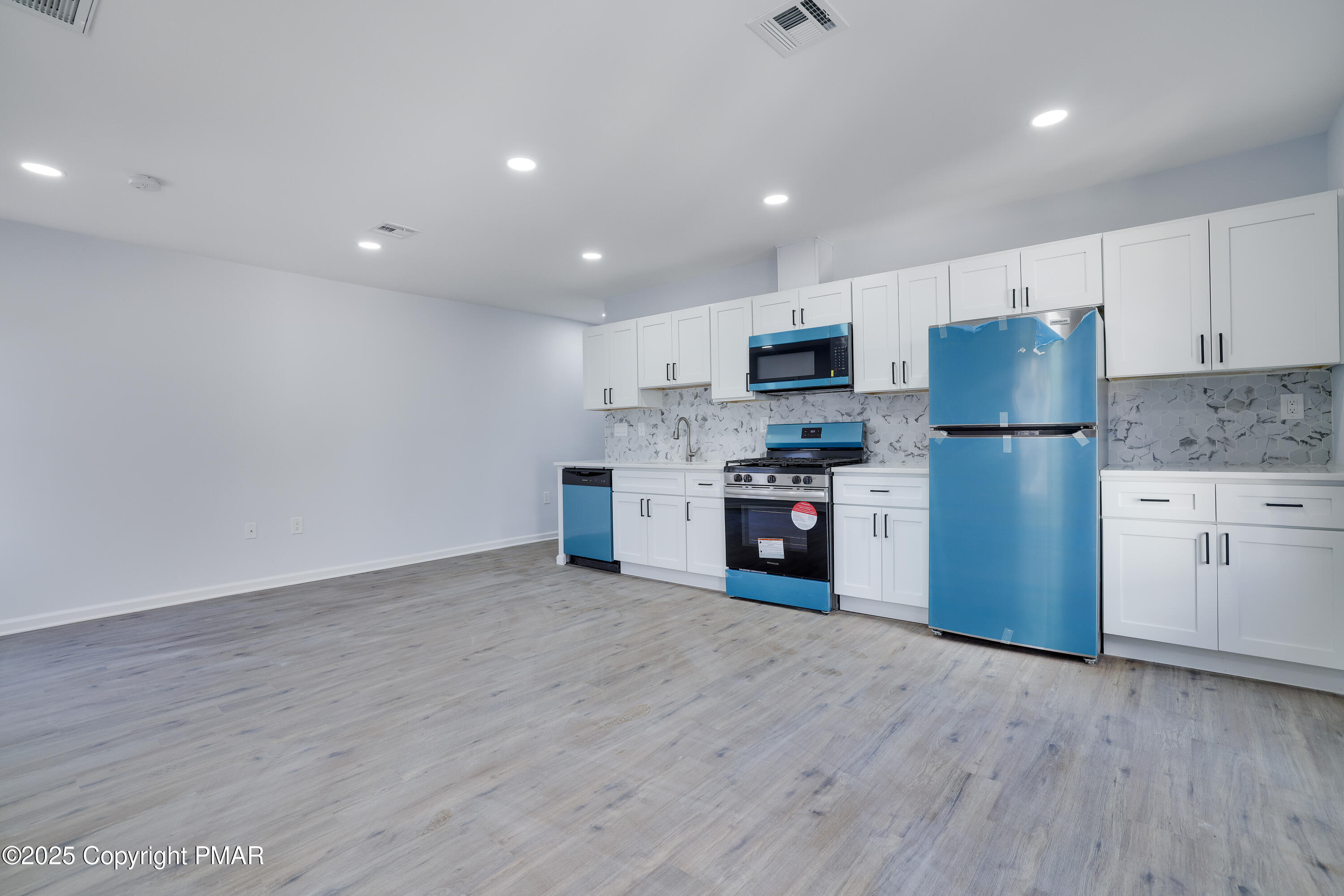 523 Sarah Street, Unit C Stroudsburg, PA 18360 - Photo 7 of 16 a kitchen with stainless steel appliances a refrigerator sink and microwave