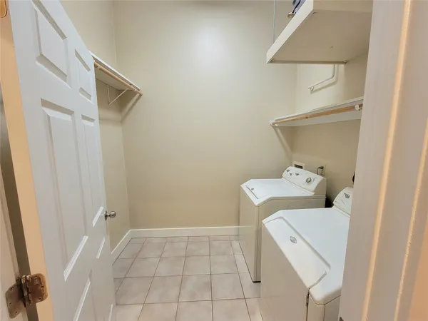 a view of a room with a sink and a mirror