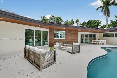 a view of a swimming pool with chairs
