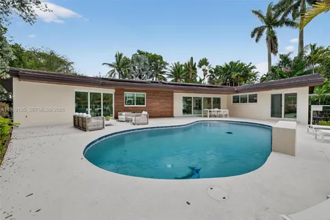 a view of swimming pool with table and chairs