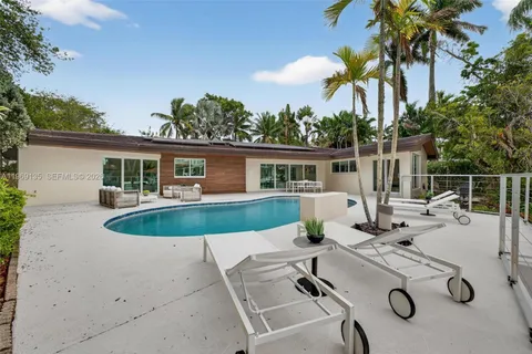 a view of a swimming pool with an outdoor seating