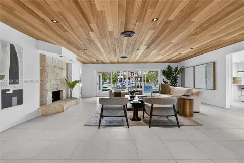 a living room with furniture a fireplace and a table
