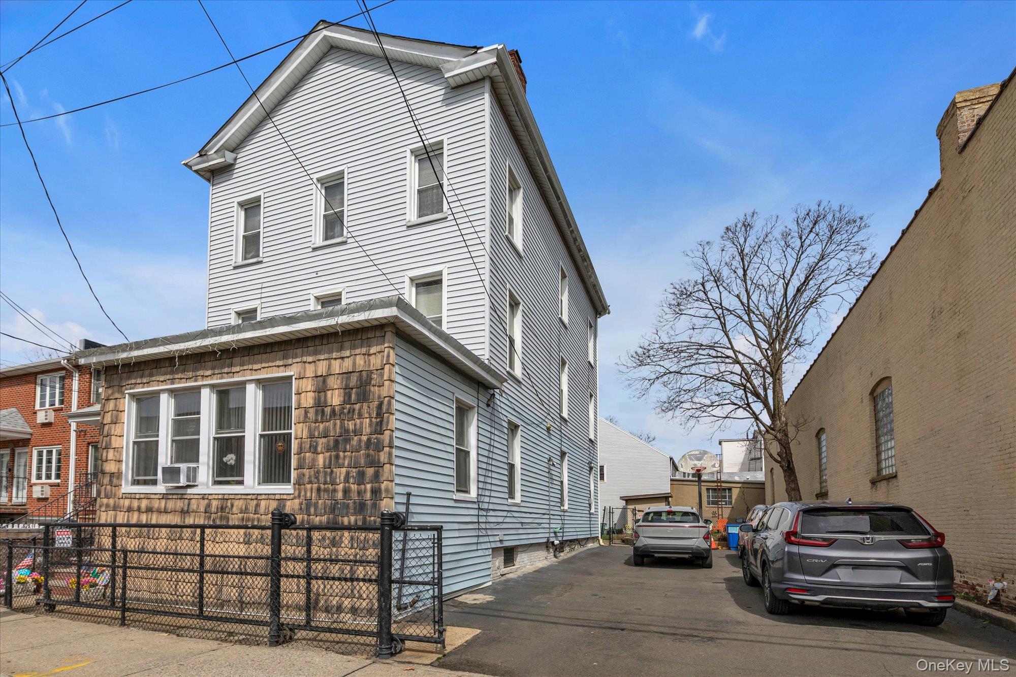 117-11 14th Road Queens, NY 11356 - Photo 1 of 23 View of front of property and the private parking area that holds 4-6 cars.