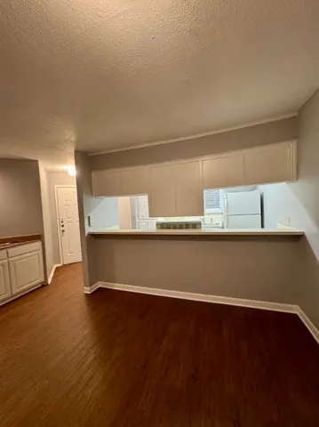a view of room with window and wooden floor
