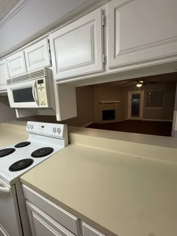 a kitchen with a stove and a microwave