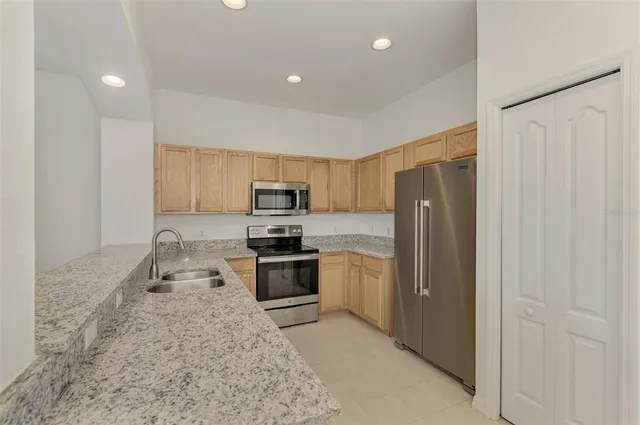 a bathroom with a granite countertop sink and shower