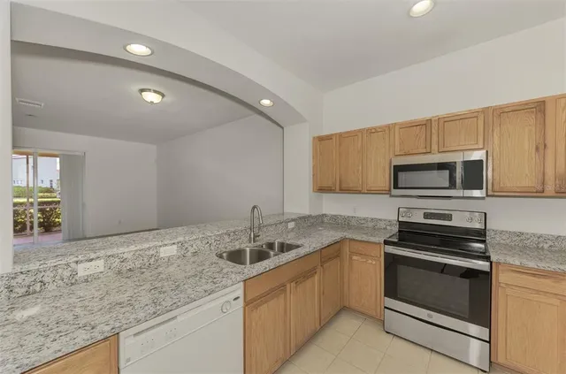 a kitchen with a sink and large window