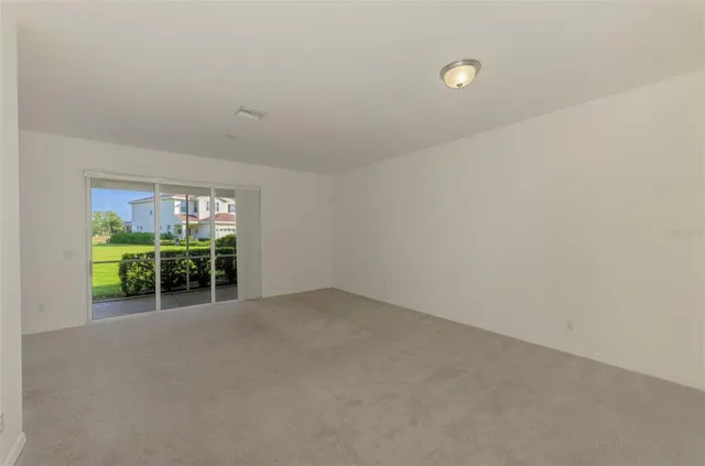 a view of a big room with closet and windows