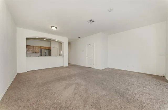 a kitchen with granite countertop a refrigerator stove and microwave