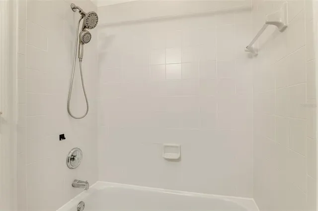 a view of a green field with some trees in the background