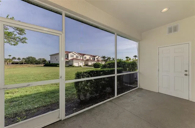 an aerial view of ocean and residential houses with outdoor space