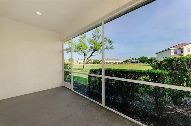 an aerial view of a house with a garden and lake view
