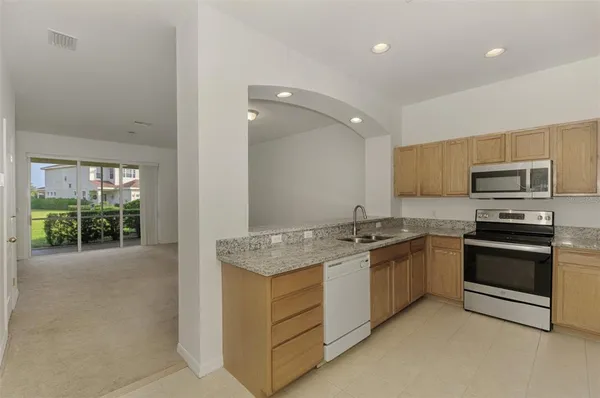 a kitchen with a sink stove and refrigerator