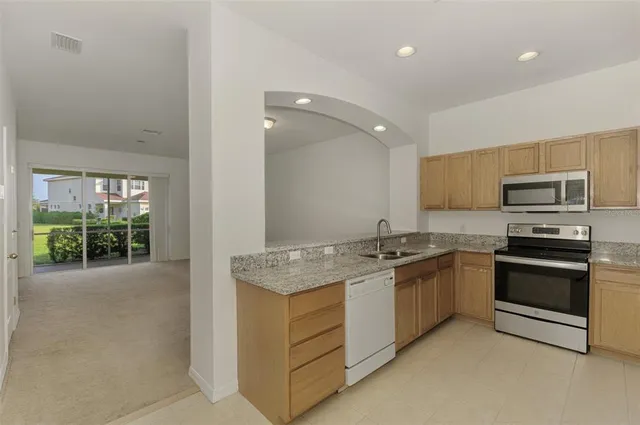 a kitchen with a sink stove and refrigerator