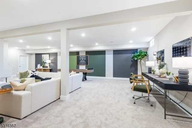 a living room with furniture and a dining table with kitchen view