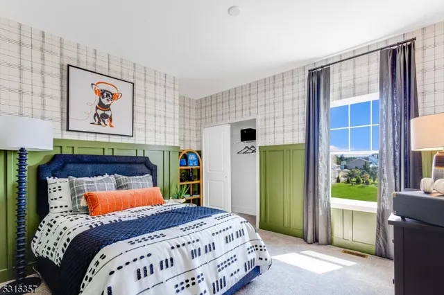 a bedroom with a bed and a painting on the wall