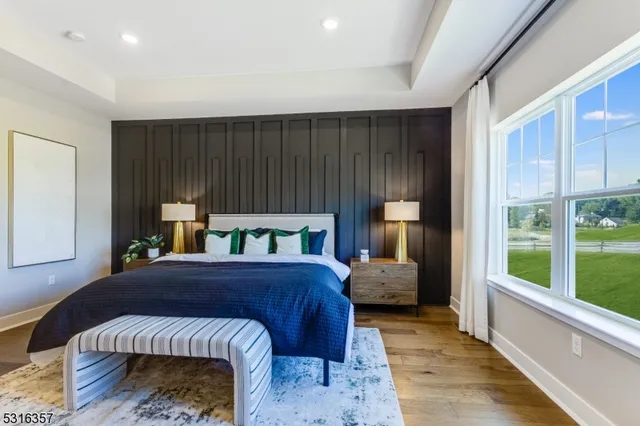 a bedroom with a bed and large window