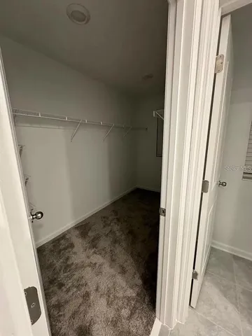 a kitchen with stainless steel appliances a refrigerator sink and white cabinets