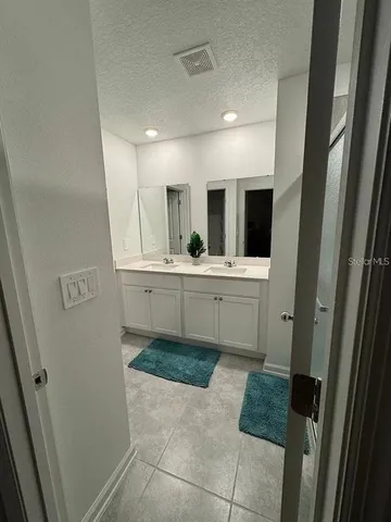 a kitchen with a sink and wooden floor