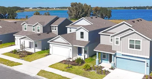 a view of the patio with a table and chairs under an umbrella with palm trees