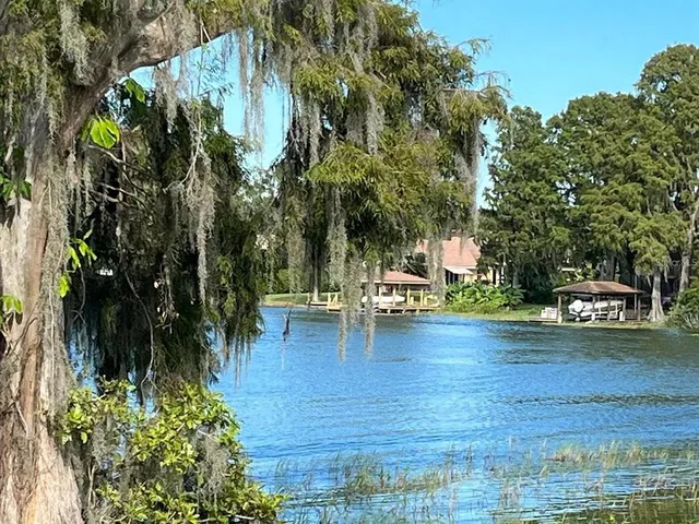 a view of a house with swimming pool and sitting area
