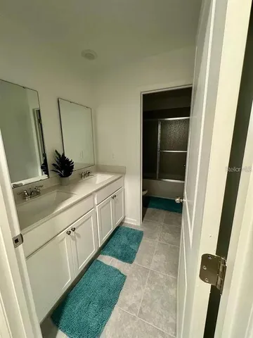 a bathroom with a sink and mirror