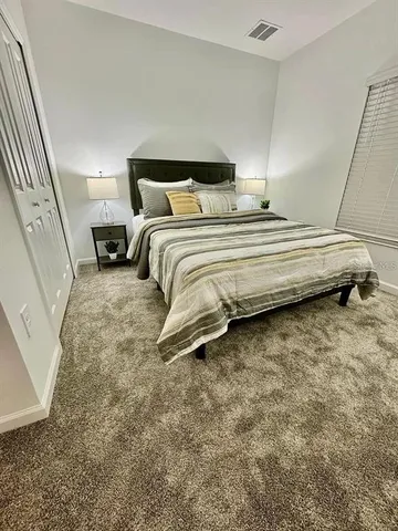a bedroom with a bed and a mirror