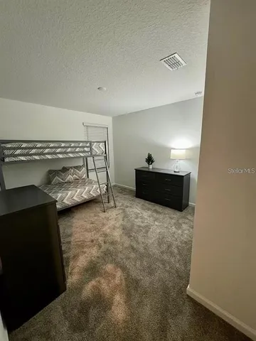 a living room with lots of furniture and kitchen view