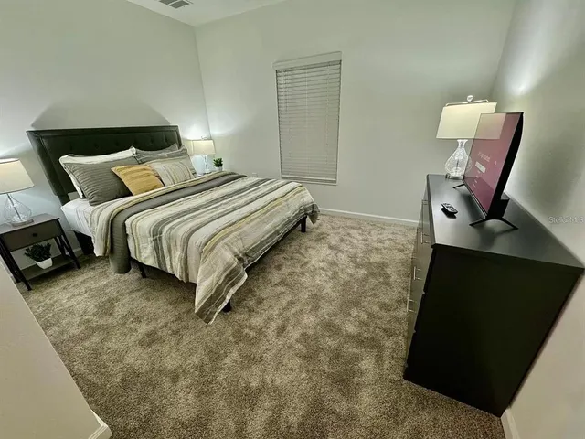 a living room with a couch and a stove top oven