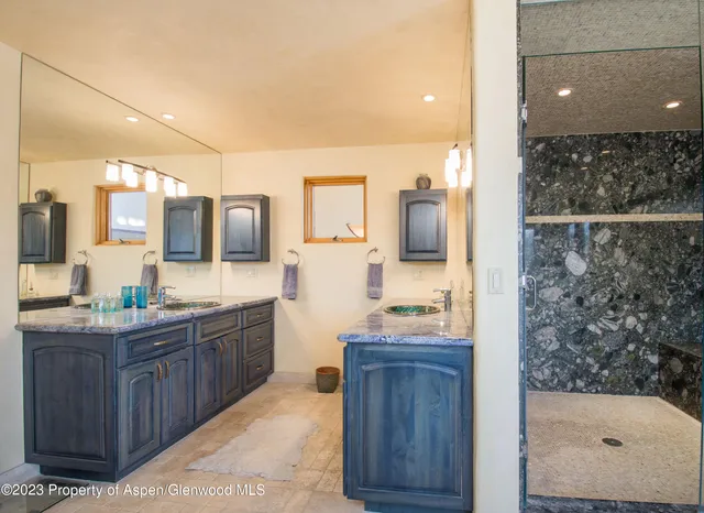 a bathroom with a granite countertop sink mirror and double