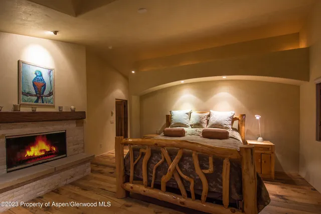 a bedroom with furniture and a fireplace