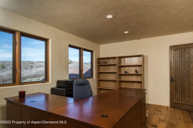 a room with furniture pool table and windows