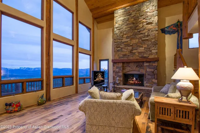 a living room with furniture a fireplace and a window
