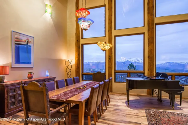a view of a dining room with furniture one side and wooden floor