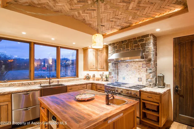 a kitchen with a sink stove and cabinets