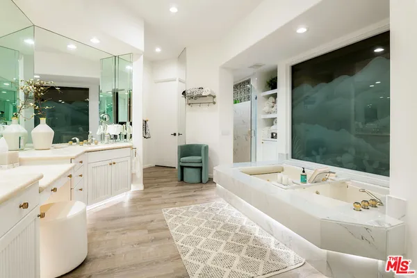 a bathroom with a sink mirror vanity and toilet