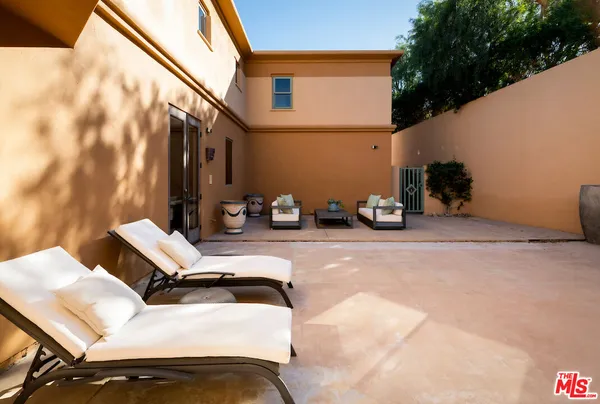 a view of a couches and lounge chairs in patio
