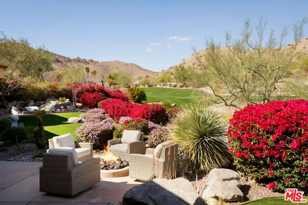 a view of a swimming pool with a patio and a garden