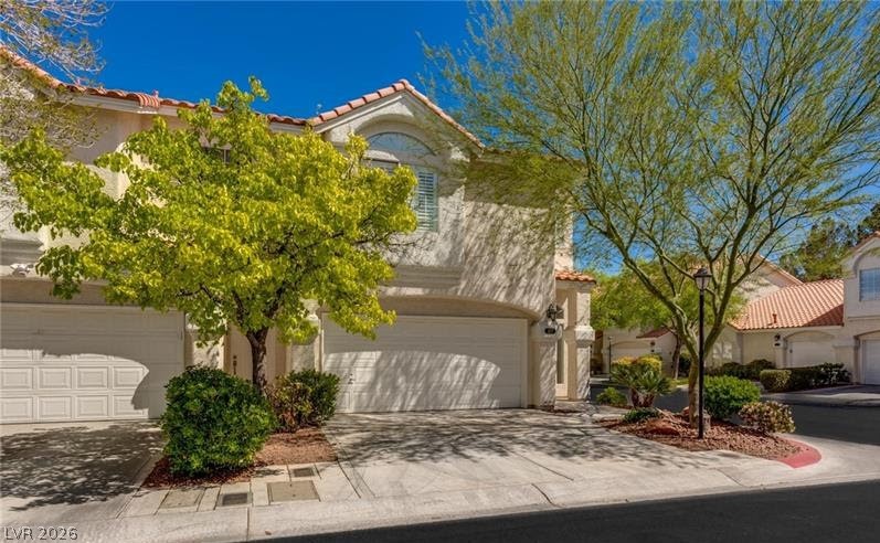 5272 Island Chain Road Las Vegas, NV 89118 - Photo 2 of 31 A graceful stucco facade and terracotta rooflines define this appealing residence.