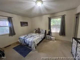 a bedroom with a bed and window