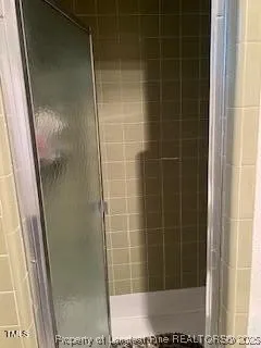 a bathroom with a glass door shower