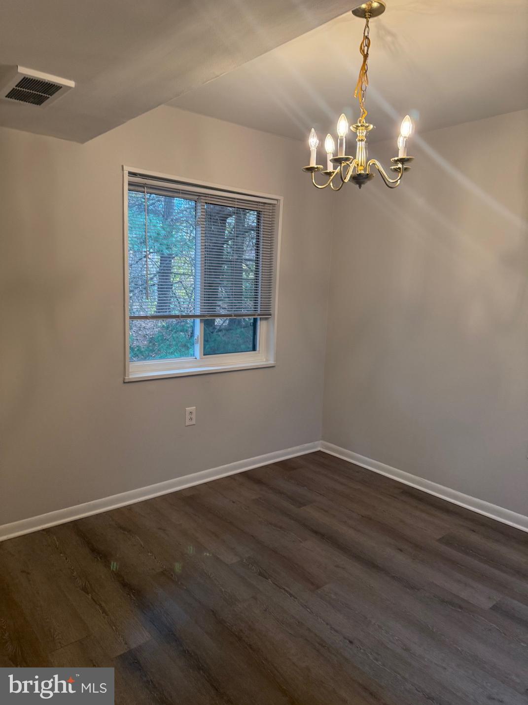 1400 Northgate Square, Unit 11A Reston, VA 20190 - Photo 13 of 21 a view of an empty room with wooden floor and a window