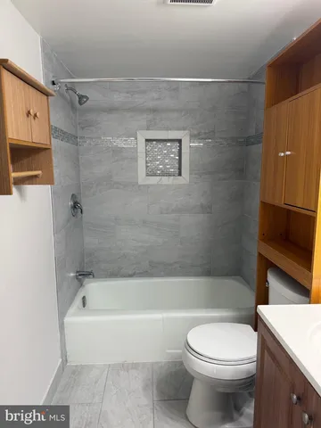 a bathroom with a toilet and a bathtub