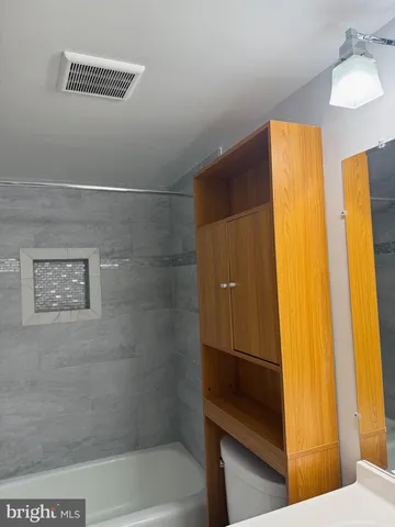 a utility room with cabinets washer and dryer