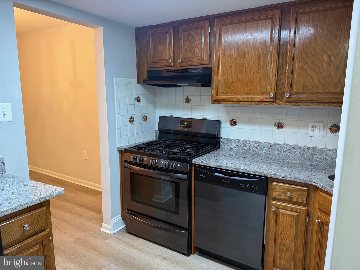 1400 Northgate Square, Unit 11A Reston, VA 20190 - Photo 3 of 21 a kitchen with granite countertop cabinets stainless steel appliances and a counter space