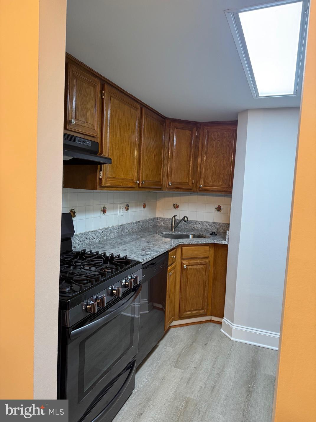 1400 Northgate Square, Unit 11A Reston, VA 20190 - Photo 6 of 21 a kitchen with granite countertop a stove top oven sink and cabinets