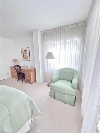 a living room with furniture and a bed