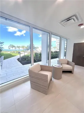 a living room with couch and a floor to ceiling window