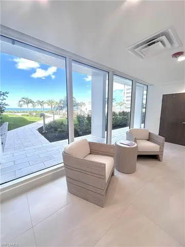 a living room with couch and a floor to ceiling window