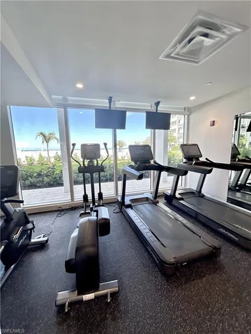 a room with gym equipment and a table